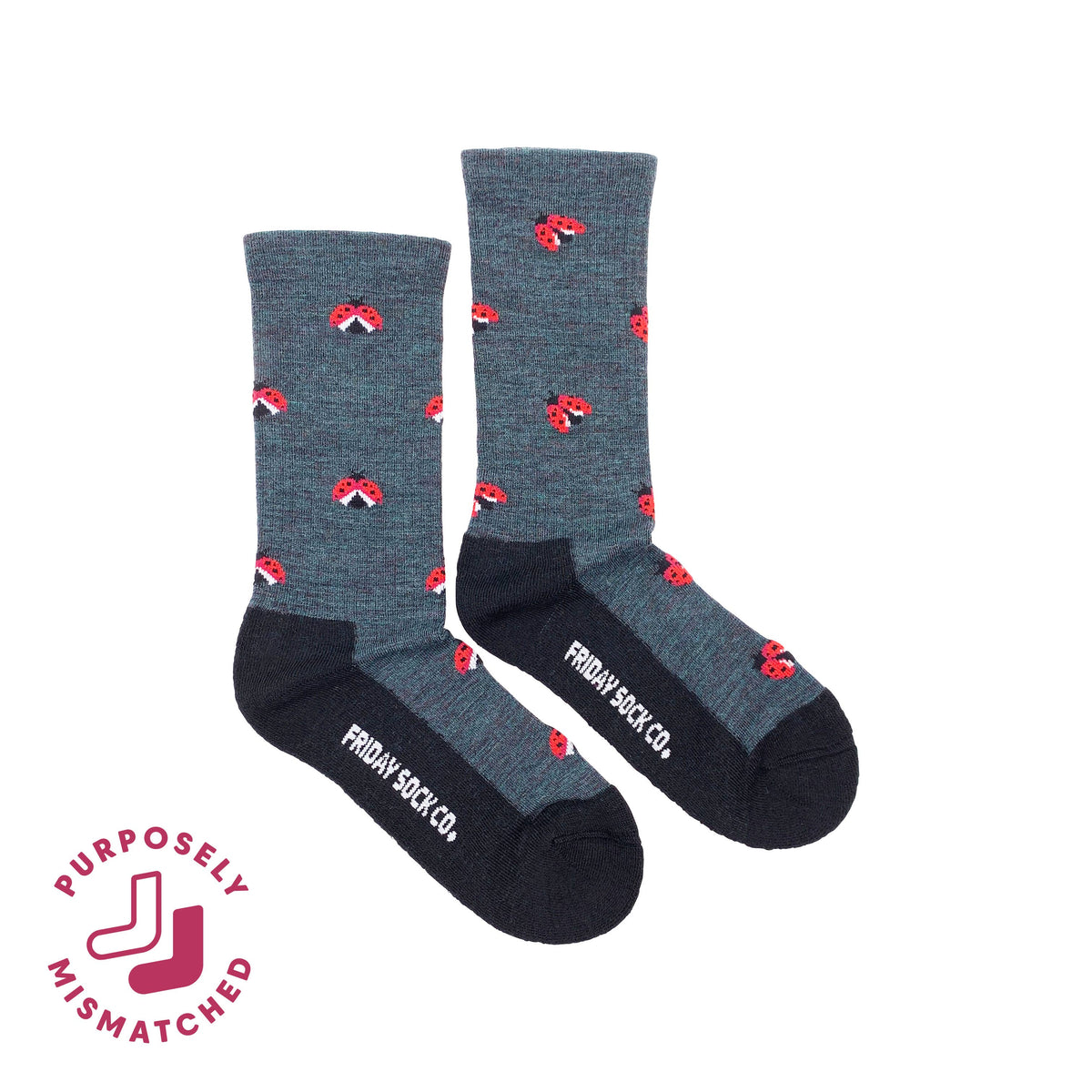 A pair of crew socks from Friday Sock Co. in heathered dark gray with black toes, heels, and soles, decorated with small mismatched ladybugs.
