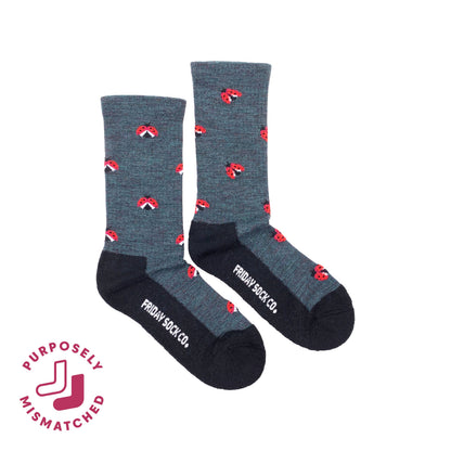 A pair of crew socks from Friday Sock Co. in heathered dark gray with black toes, heels, and soles, decorated with small mismatched ladybugs.
