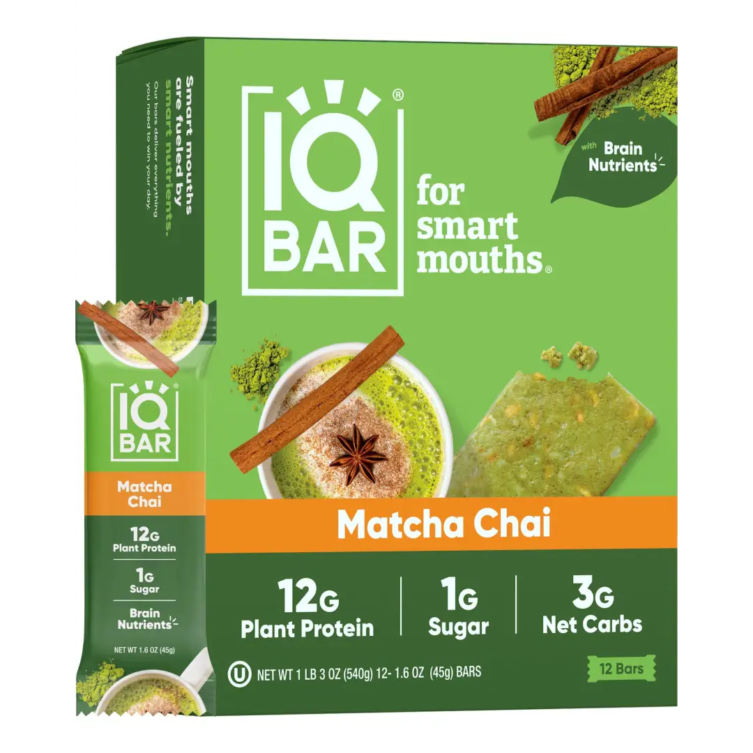IQ Bar Matcha Chai snack box with a single bar packet shown beside it on a plain white background. The packaging is predominantly green with orange accents and product imagery of matcha, cinnamon, and star anise.