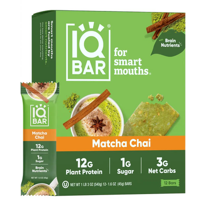IQ Bar Matcha Chai snack box with a single bar packet shown beside it on a plain white background. The packaging is predominantly green with orange accents and product imagery of matcha, cinnamon, and star anise.