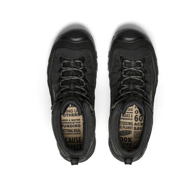 Black Keen hiking boots with on the sole against a white background