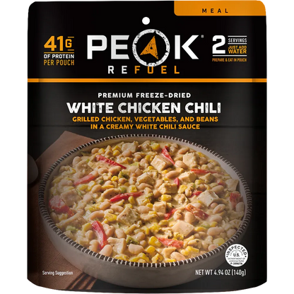 Peak Refuel White Chicken Chili package with a bowl of chili on a black background
