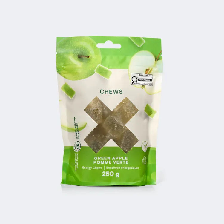 A 250g pouch of Xact Green Apple Energy Minis shown with bite-sized, soft fruit jelly chews ready for endurance fueling.