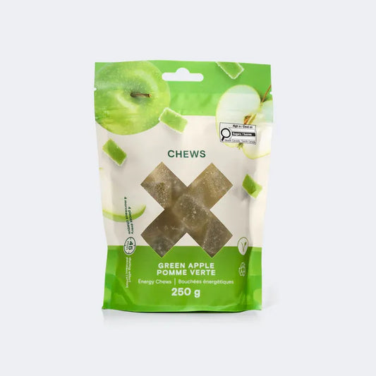A 250g pouch of Xact Green Apple Energy Minis shown with bite-sized, soft fruit jelly chews ready for endurance fueling.