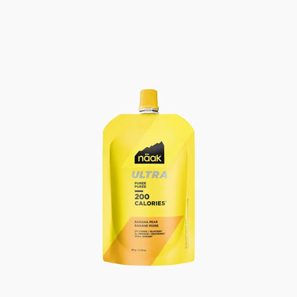 A yellow Naak Ultra puree pouch with banana pear flavor, featuring a yellow cap and a black mountain logo, set against a plain white background.